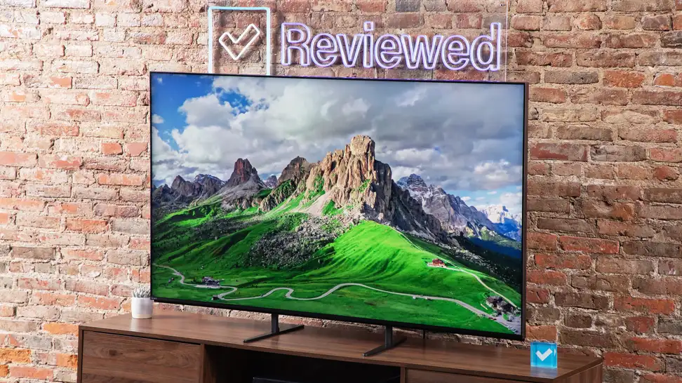 A Sony Bravia 9 Mini-LED TV sitting on a wood entertainment center, with a picture of a mountain on the screen.