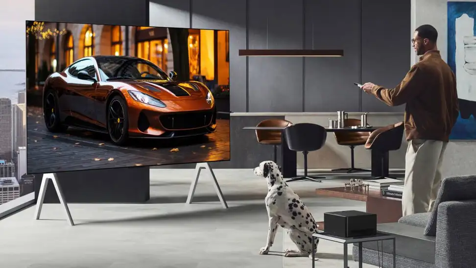 Man and dog watch an LG OLED television