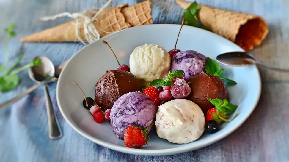Scoops of gelato and fresh fruit in a bowl