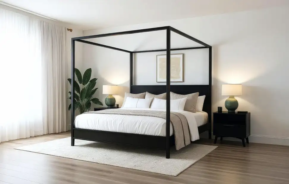 A black wooden canopy bed from Plank+Beam