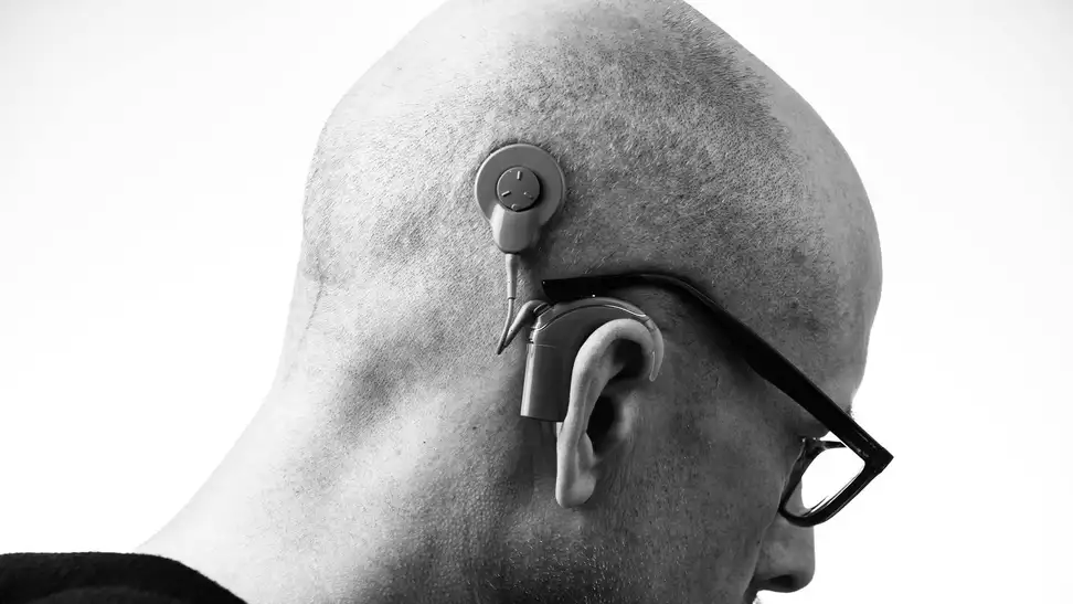 Grayscale photo of a man with a hearing aid