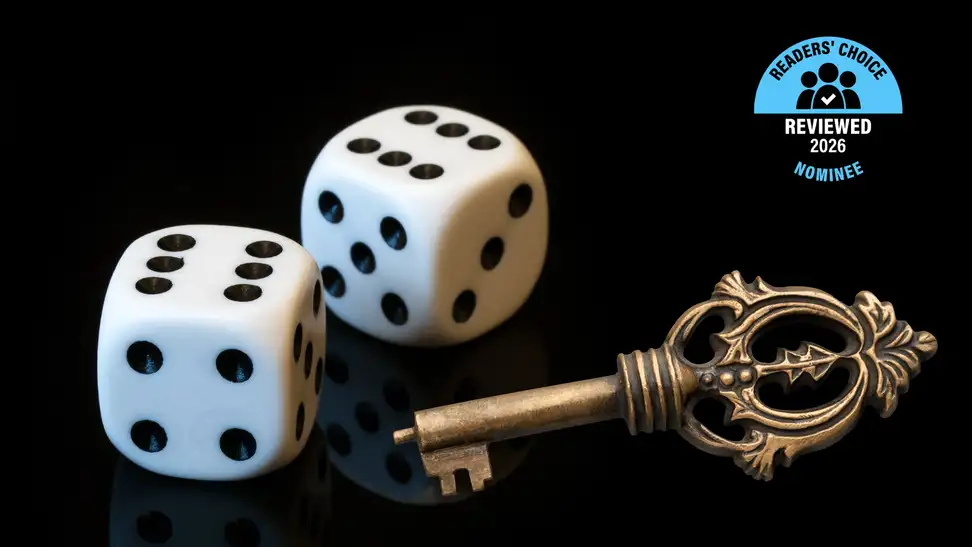 A pair of dice and a key on a black background