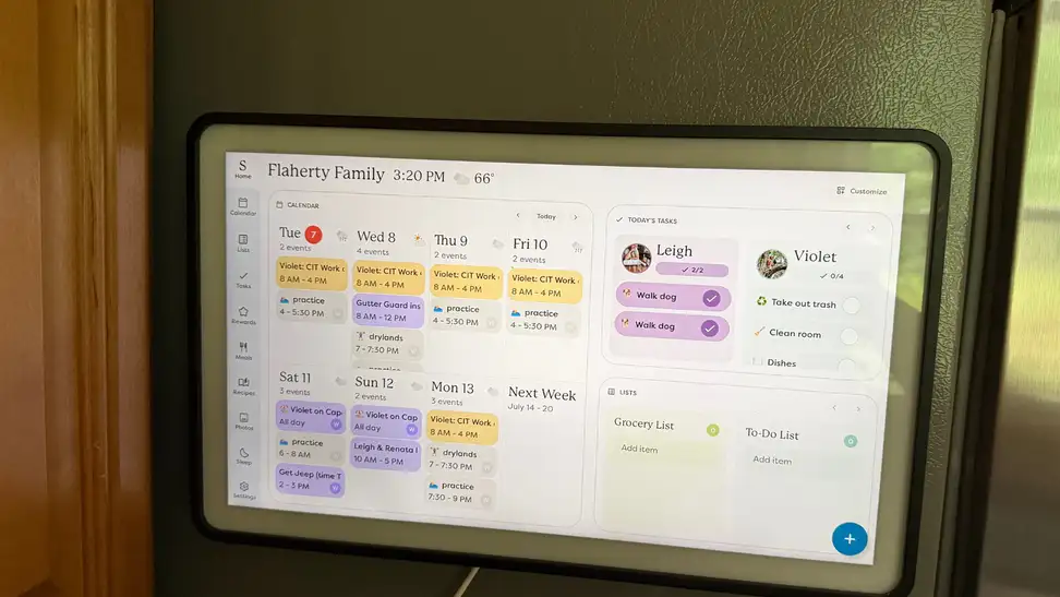 Skylight Calendar 2 showing calendar entries and tasks, mounted on a silver refrigerator.