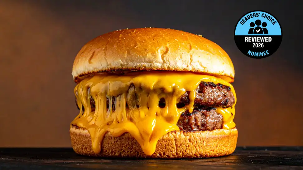 A large double patty burger drips with orange cheese