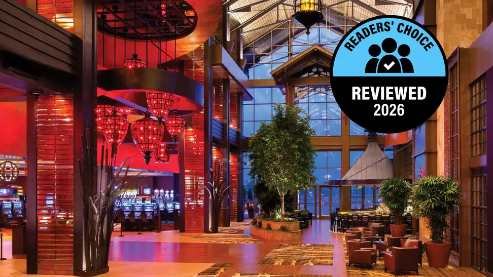 A hotel lobby with red lights and an award badge on the photo