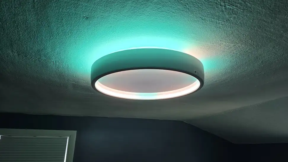 Govee Sky Ceiling Light glowing turquoise on a ceiling.