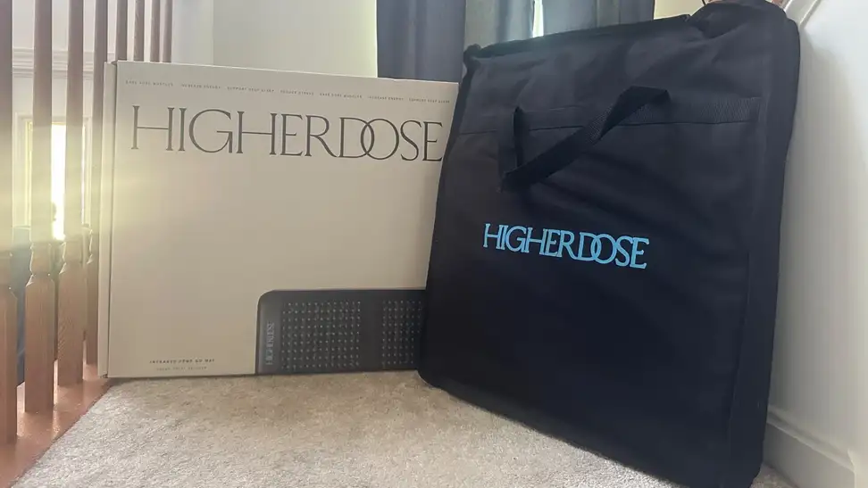 HigherDOSE PEMF Go Mat case sits on stairs with box nearby