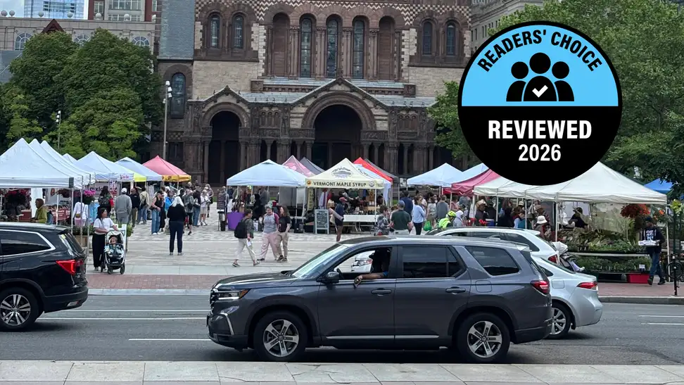 A farmers market stands in front of a brown church landmark in Boston