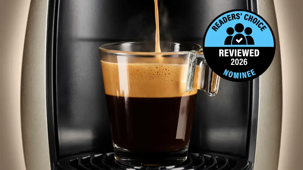A rich cup of coffee is being brewed