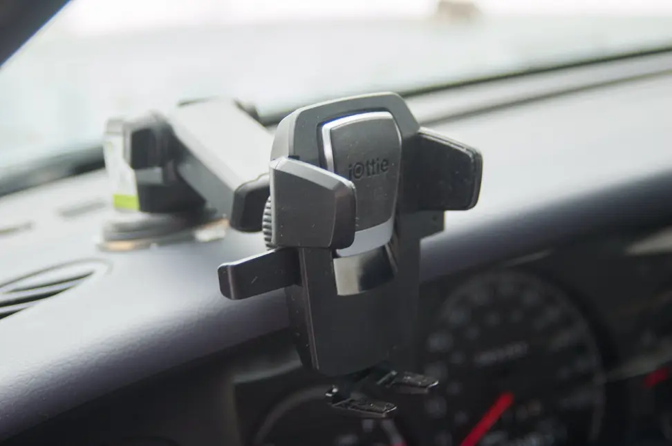 A phone holder mounted to the dashboard of a car