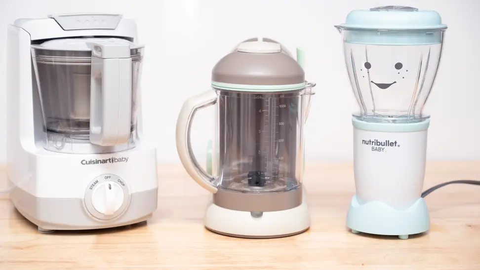 Three different baby food makers sit on a kitchen counter.
