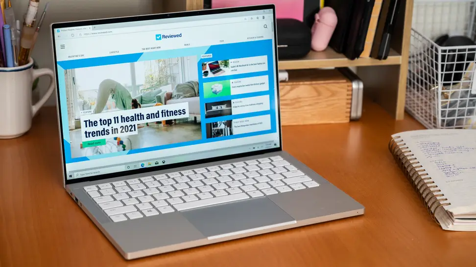 The laptop is on a desk, its bright screen the focus of the image.
