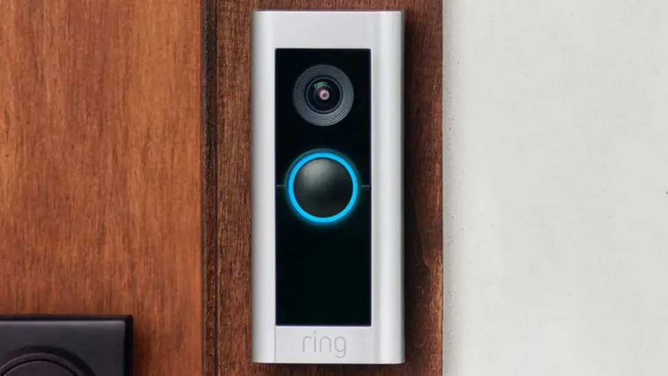 The Ring Video Doorbell Pro 2 hangs on a wooden front door.