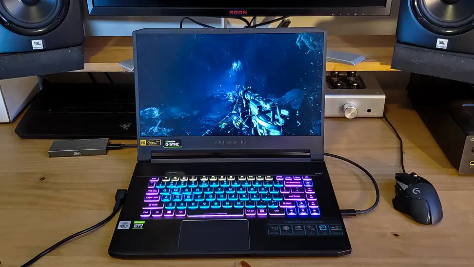 The Triton 500 sits on a desk next to a mouse