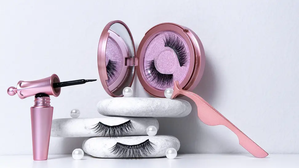 A set of magnetic eyelashes with the corresponding magnetic liner and tweezers staged on a white background.