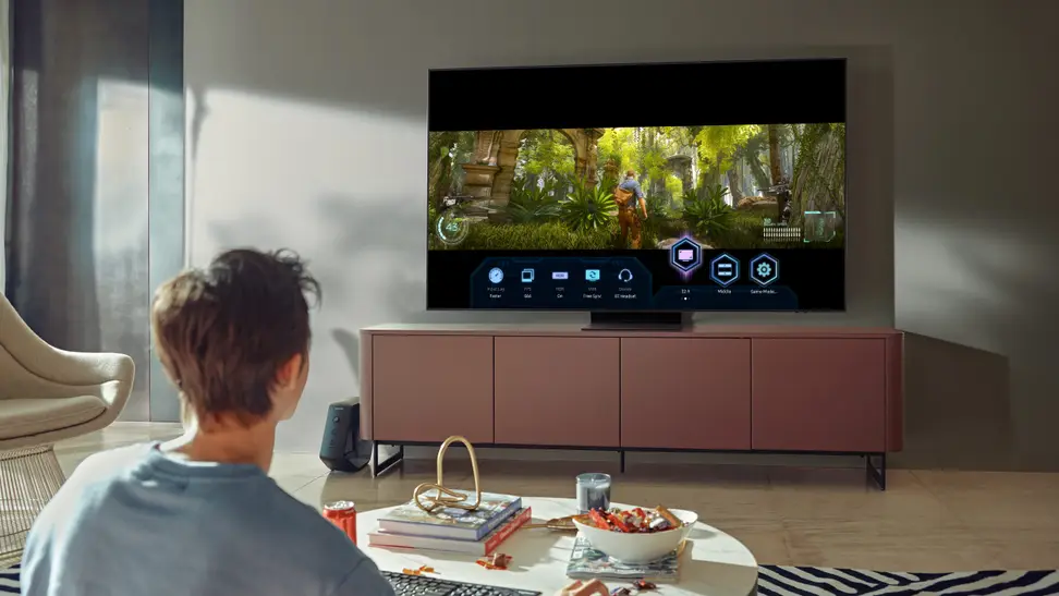Man sitting in living room watching Samsung TV.