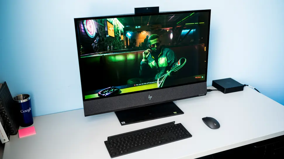 The HP Envy All-in-one PC sits on a desk, with the keyboard and mouse in front of it