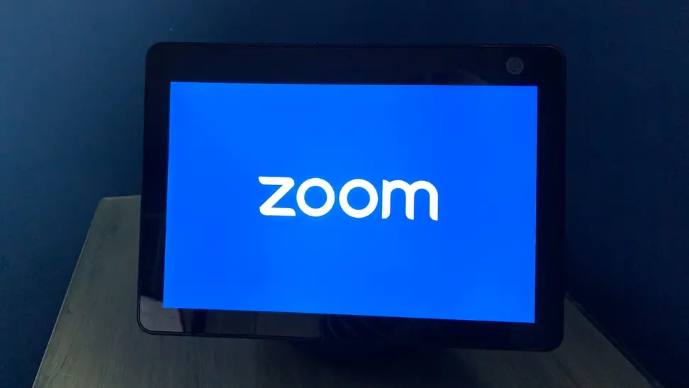 Amazon Echo Show 10 smart display sits on a nightstand.