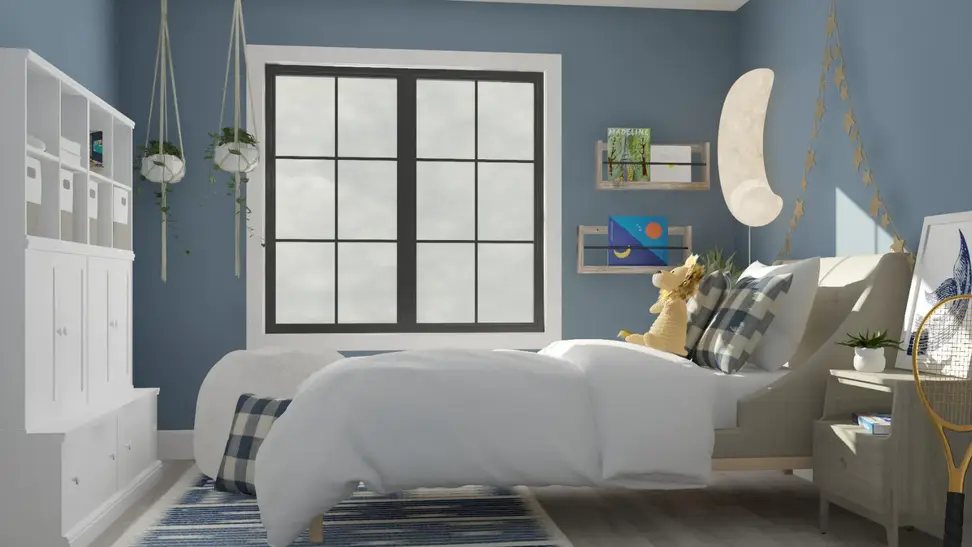 A big kid room with a large bed, blue walls, and big bright window