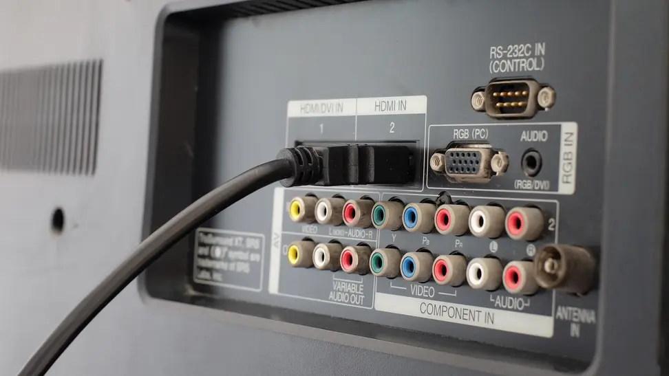 An HDMI cable plugged into a TV's ports