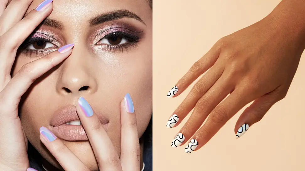 On the left: A woman wearing dramatic makeup stares at the camera and holds her holographic blue nails from Static Nails up to her face. On the right: A hand comes from the upper right corner of the frame pointing down toward the left corner of the frame wearing white Chillhouse nails with black squiggles on them.