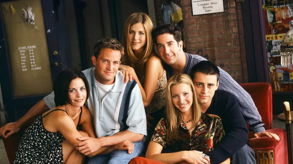 The cast of the show "Friends" in a coffee shop, among the best '90s tv shows to stream now.