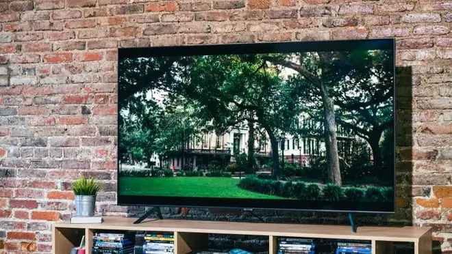 Samsung TV against a red brick wall