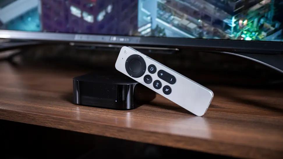 The Apple TV 4K (2021) with remote next to a TV