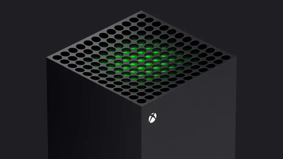 The top of a gaming console with a glowing green center