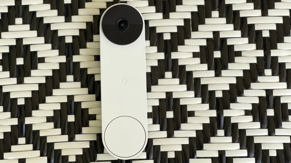 The Nest Doorbell (battery) on a black and white chair.