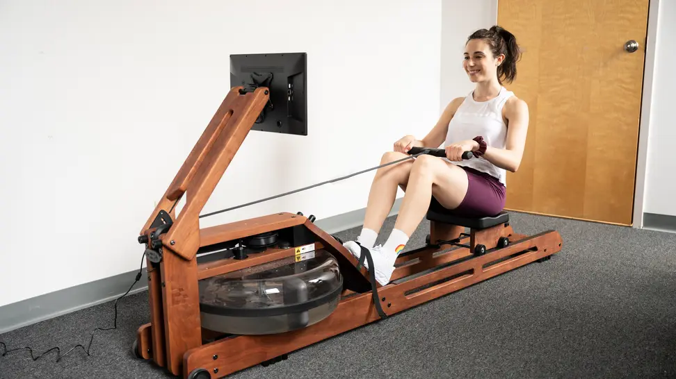 Woman rowing on Ergatta rowing machine.