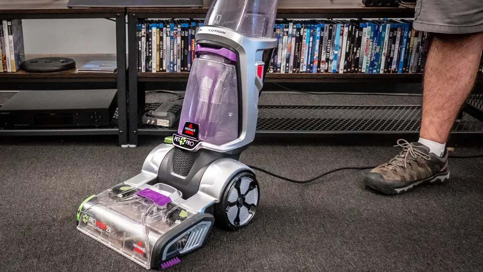 A vacuum stands in a room on a carpet