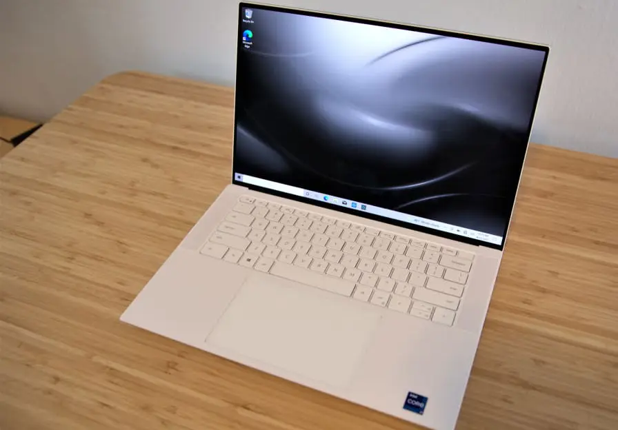 A Dell XPS 15 with OLED display on a desk.