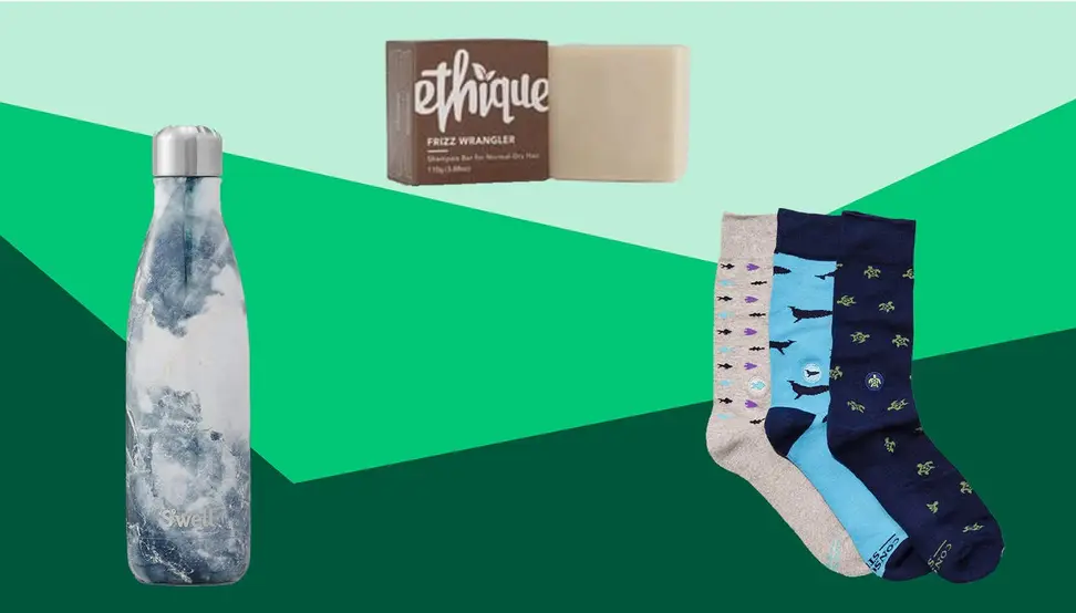 A S'well water bottle, shampoo bar, and three pairs of socks on a green background