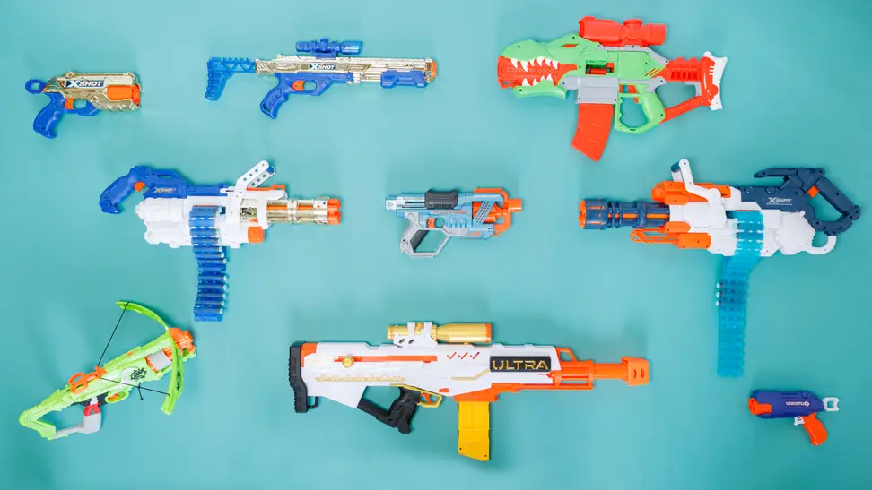 10 different Nerf guns on a light blue background