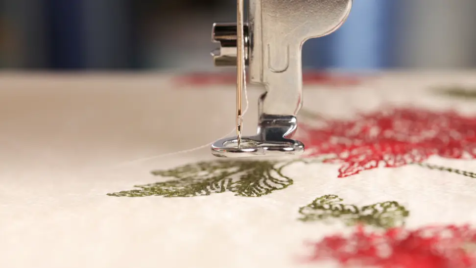 Embroidery machine embroidering cloth.