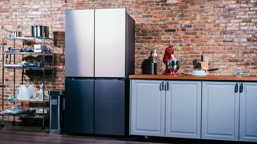 A sleek French-door fridge is standing in a kitchen