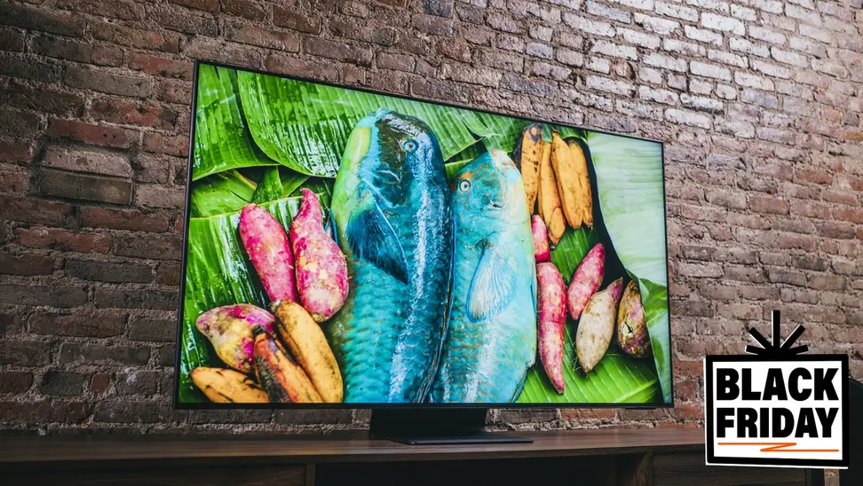 TV on wooden stand in front of brick wall