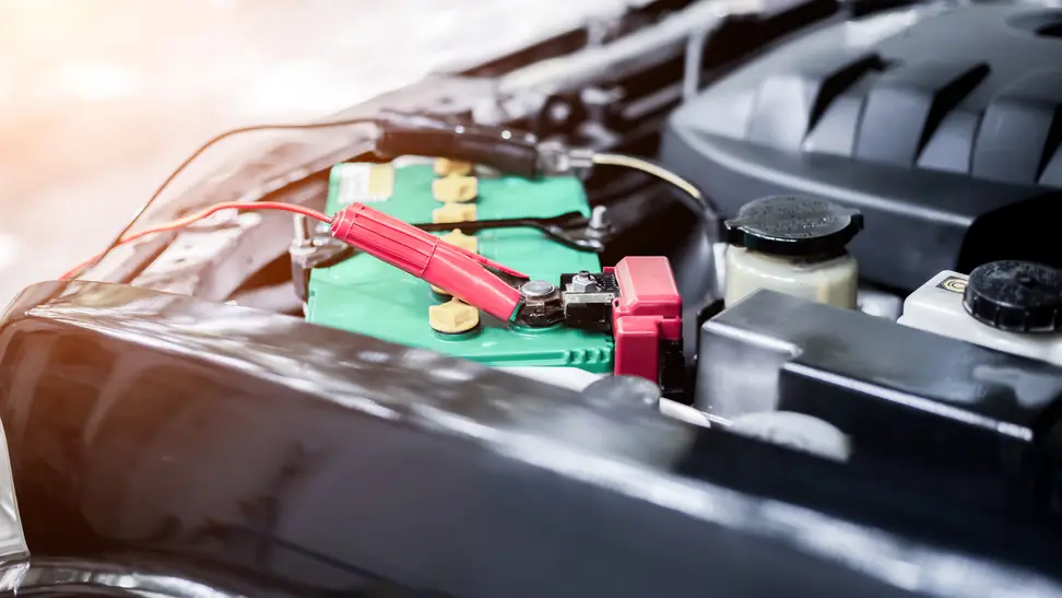 Charging car with electricity and jumper cables.