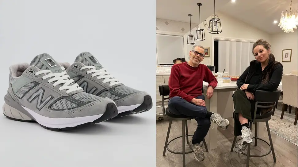 Pair of grey New Balance 990v5 sneakers, father and daughter sitting together at table in a pair of NB 990v5 sneakers.