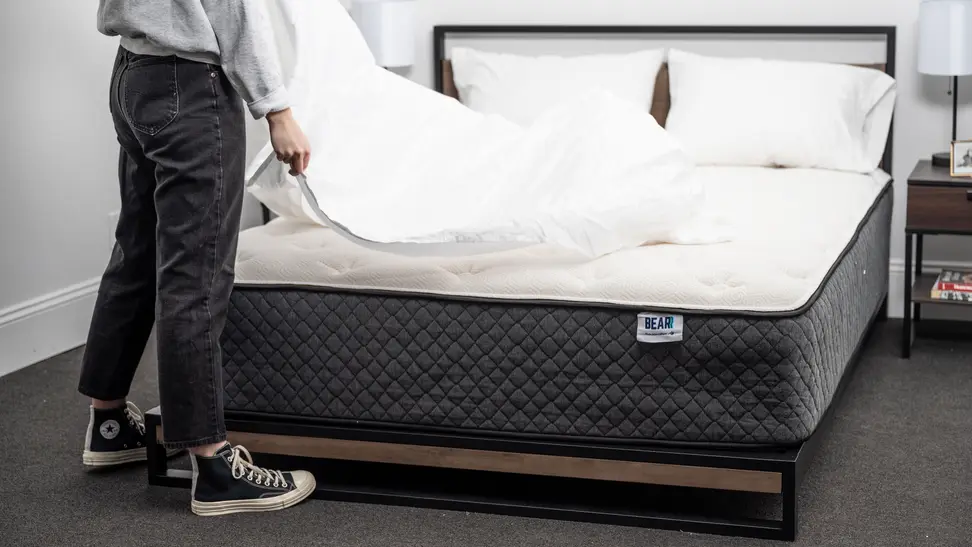 person puts cover on bear mattress