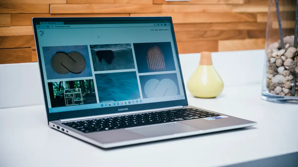An open and powered on laptop sitting on a desk