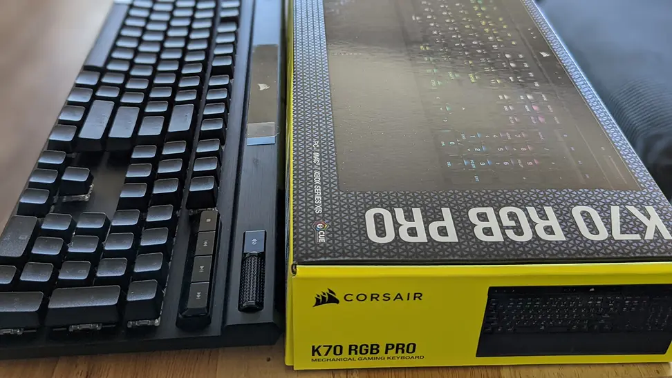 A keyboard next to its packaging box