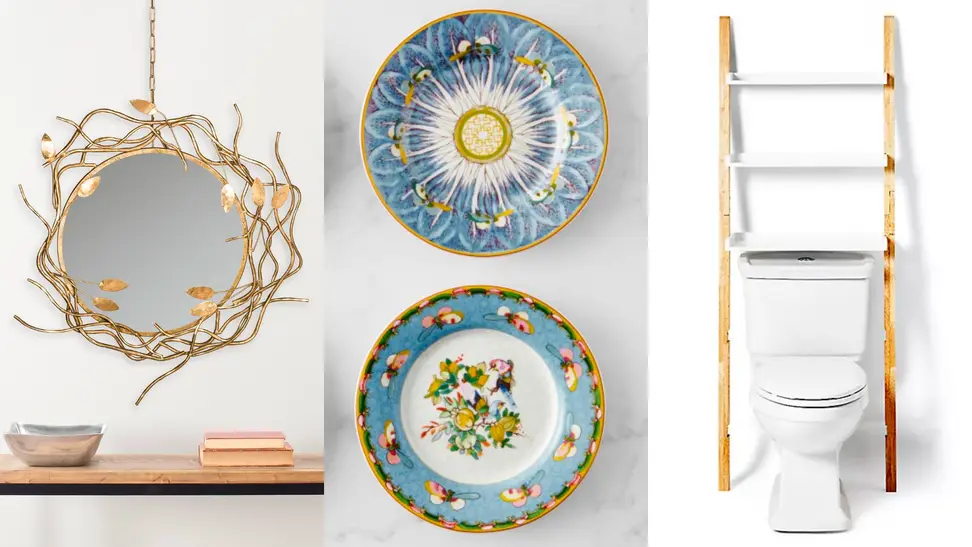 1) A golden twig mirror against a wall 2) Two blue patterned plates hang on a wall 3) A storage ladder leans against a wall.