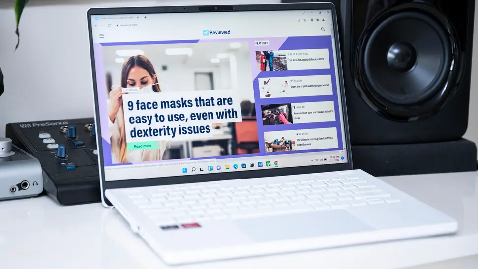 An open and powered on laptop sitting on a desk