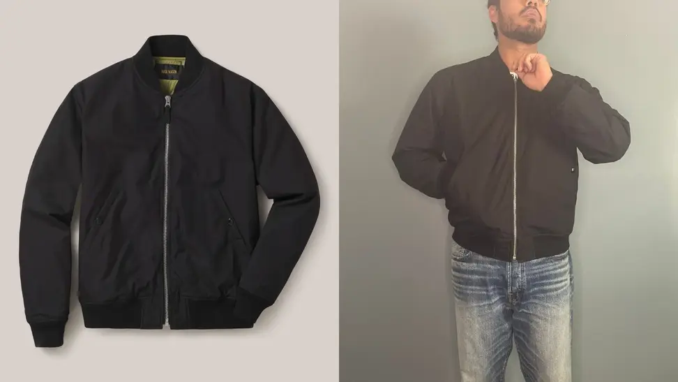 Bomber jacket from Buck Mason, man standing in Buck Mason bomber jacket.