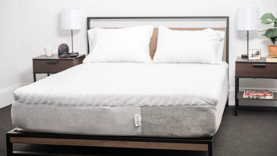 White mattress with pillows but without sheets.