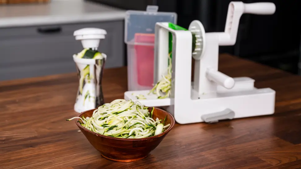 A bowl of zoodles created by the best spiralizers are displayed on a kitchen counter.