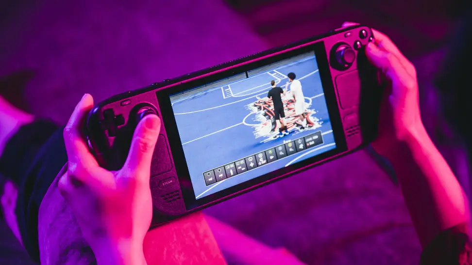 A person holding a handheld gaming device