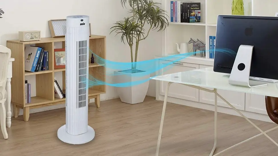 A tower fan providing ventilation in a home office space.